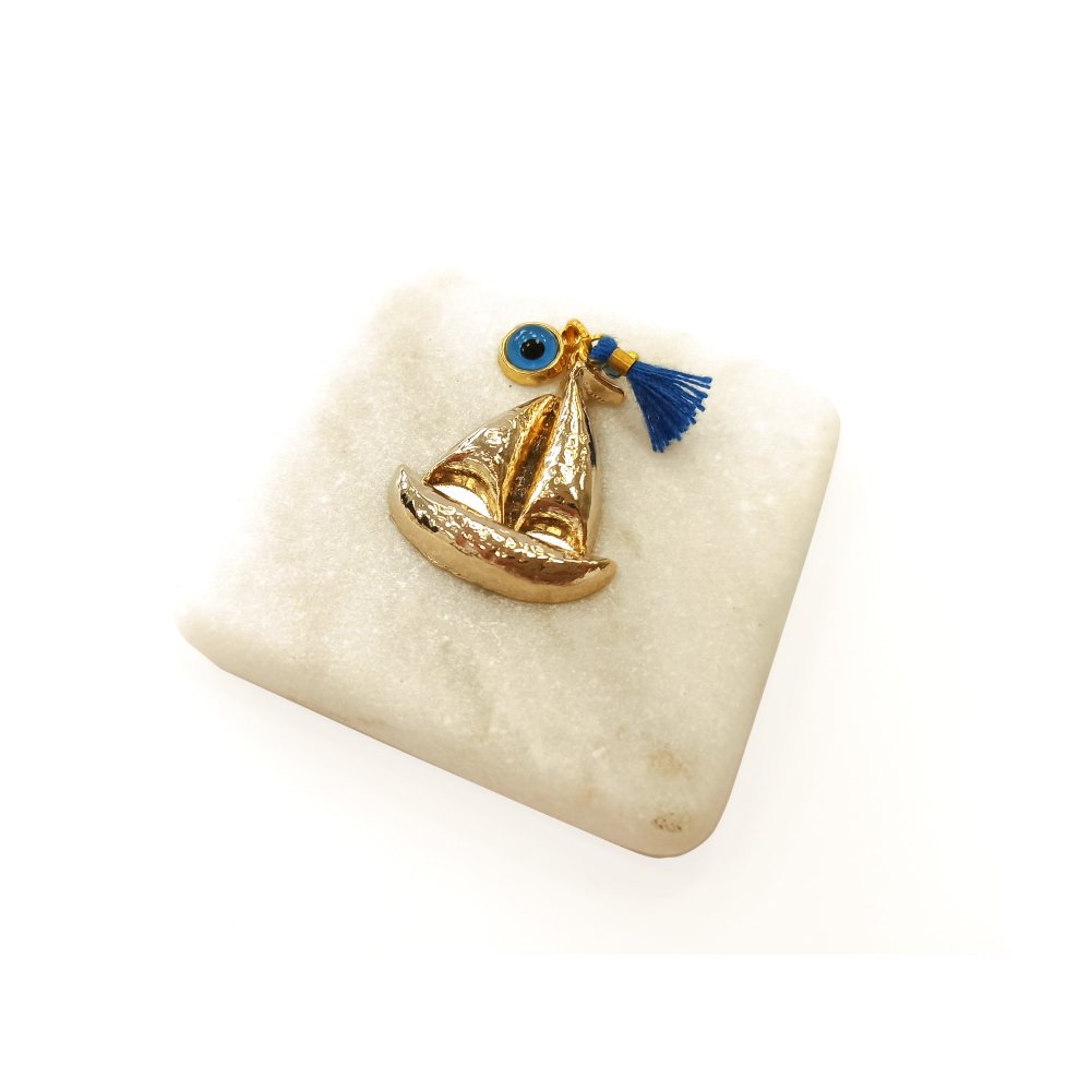 Marble table charm with a golden boat